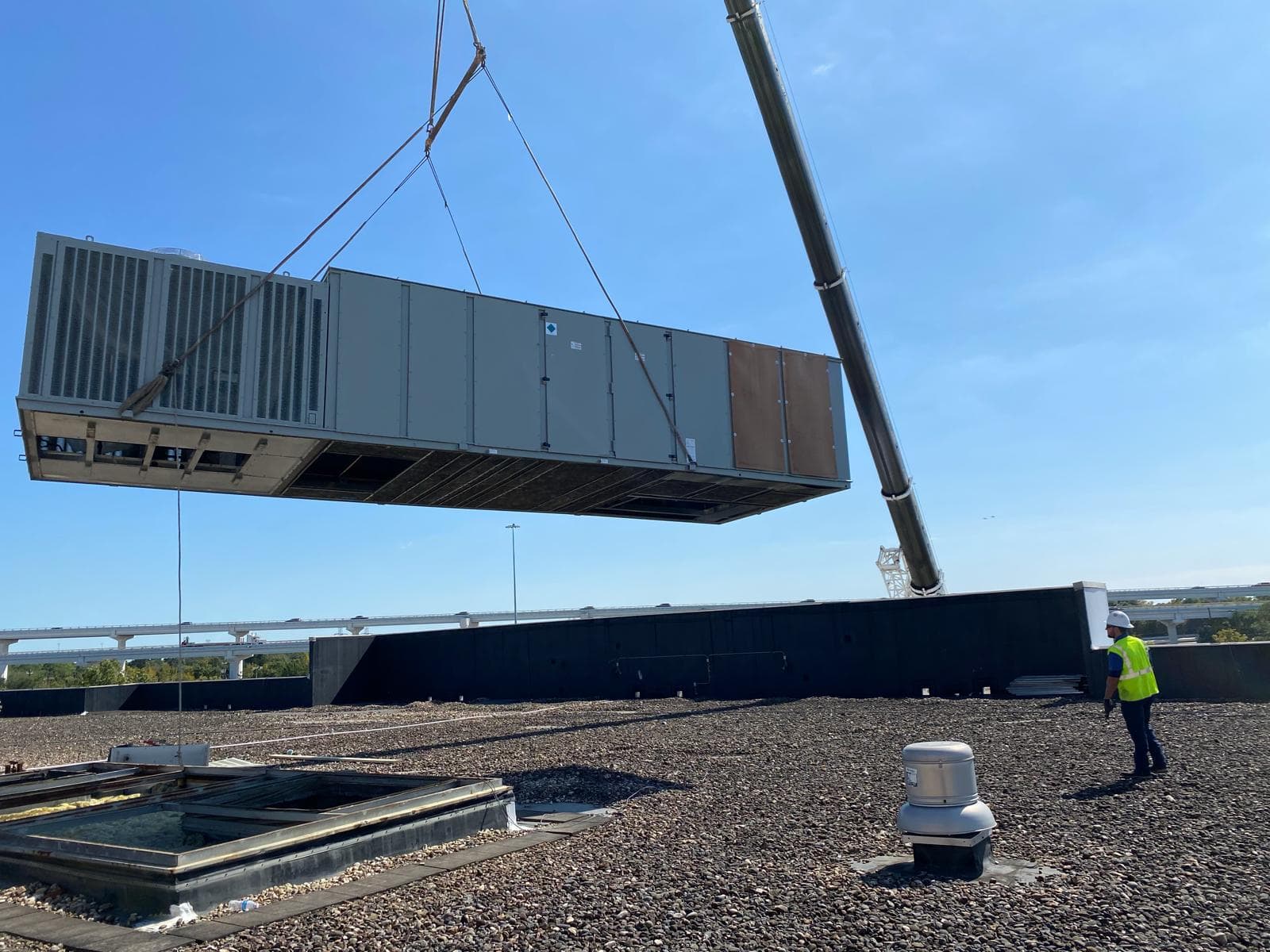 True Comfort Solutions technician servicing a rooftop HVAC unit